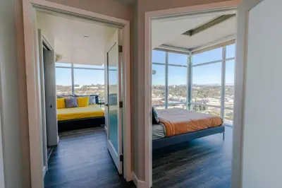 a bedroom with a bed and a window at Modern Downtown SD Apartment Stunning City Views in San Diego