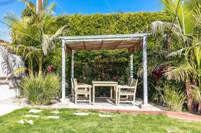 a gazebo with a table and chairs in a yard at Staycation Beach Family Home Great Indoor Outdoor in Carlsbad