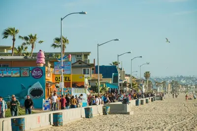 a crowd of people standing on a beach at Pacific Beach Cottage 4 Walk to the Beach and Bay in San Diego