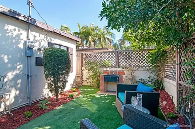 a small backyard with a patio furniture and a fence at Cute Old Town Cottage near Downtown Beaches in San Diego