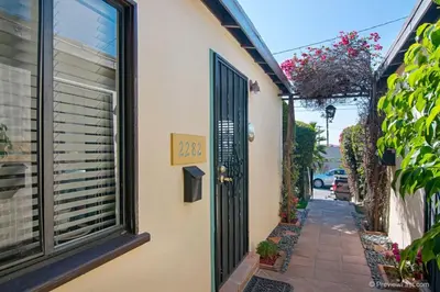 a house with a door and a street at Cute Old Town Cottage near Downtown Beaches in San Diego