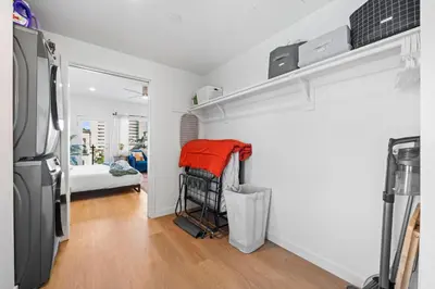 a room with a refrigerator and a room with a bedroom at Stylish Top-Floor Gem with King Bed & City Ocean Views in San Diego