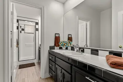a bathroom with a sink and a mirror at Lakeside Mansion Waterfront 34 beds Boat ramp in Lake Elsinore