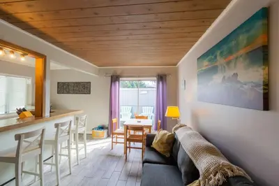 a living room with a couch and a bar at Cozy Ocean Beach Cottage Separate Entry in San Diego