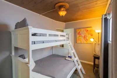 a room with two bunk beds and a ceiling at Cozy Ocean Beach Cottage Separate Entry in San Diego