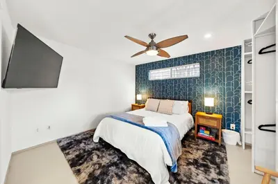 a bedroom with a bed and a ceiling fan at Decked Out Delight Park Charm in San Diego