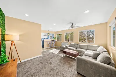 a living room with a couch and a table at Decked Out Delight Park Charm in San Diego