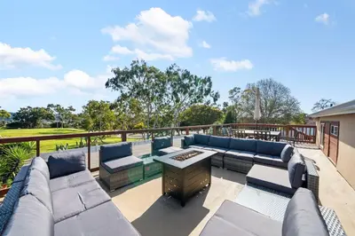 a patio with couches and a table on a deck at Decked Out Delight Park Charm in San Diego