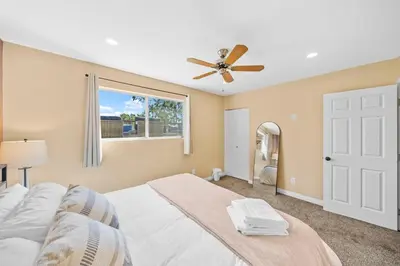 a bedroom with a bed and a ceiling fan at Decked Out Delight Park Charm in San Diego