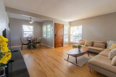 a living room with a couch and a table at Centrally Located Cottage Near Lake Trails Shops in La Mesa