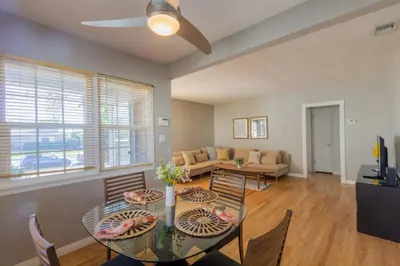 a living room with a table and chairs and a couch at Centrally Located Cottage Near Lake Trails Shops in La Mesa