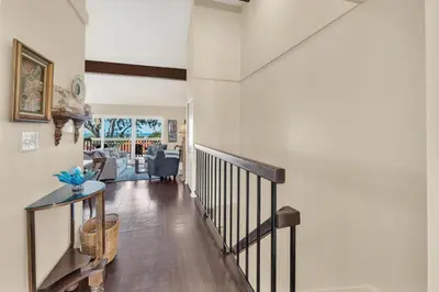 a hallway with a staircase and a living room at 2BR Condo with Views Near Shops and Food, Fast WiFi in Carlsbad
