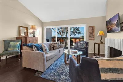 a living room with a couch and a fireplace at 2BR Condo with Views Near Shops and Food, Fast WiFi in Carlsbad