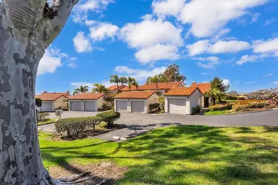 a house in a subdivision with a green yard at 2BR Condo with Views Near Shops and Food, Fast WiFi in Carlsbad