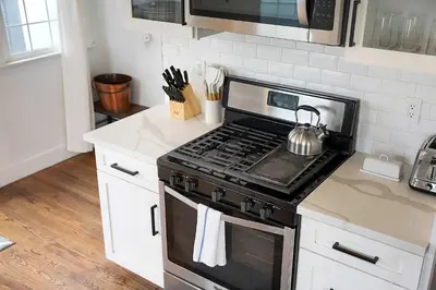a kitchen with a stove with a tea kettle on it at The Captain Quarters- Rosecrans Marina Escape in San Diego