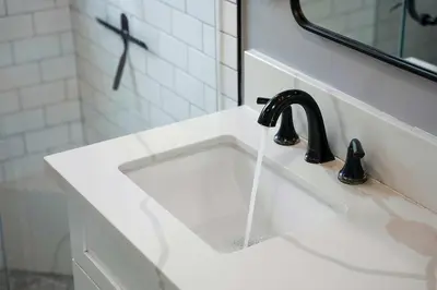 a bathroom sink with water coming out of it at The Captain Quarters- Rosecrans Marina Escape in San Diego
