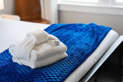 a pile of towels sitting on a bed at The Captain Quarters- Rosecrans Marina Escape in San Diego