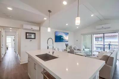 a kitchen with a sink and a living room at Bayside Cove 10 in San Diego