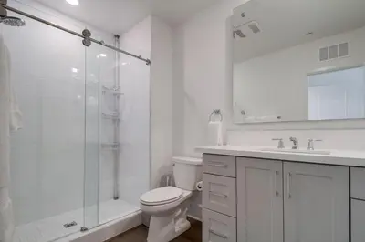 a white bathroom with a toilet and a shower at Bayside Cove 10 in San Diego