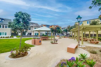 a park with picnic tables and trees and buildings at Bayside Cove 10 in San Diego