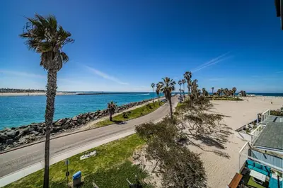 an aerial view of a beach with palm trees and a road at Ocean Vista Penthouse 2 in San Diego