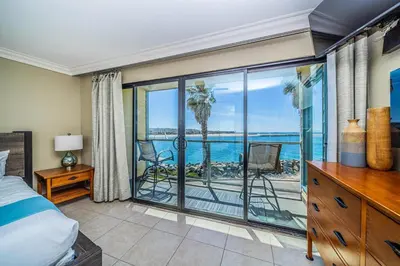 a bedroom with a bed and a view of the ocean at Ocean Vista Penthouse 2 in San Diego
