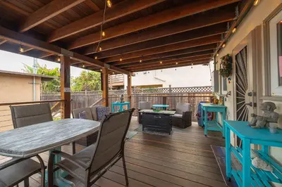 a patio with a table and chairs on a deck at Steps to Ocean Sunset Views Beach Access & San Diego Charm in San Diego