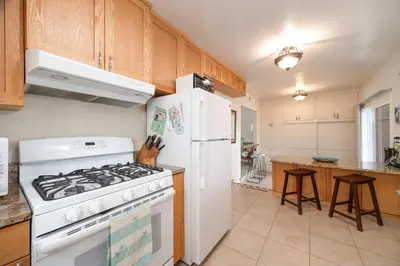 a kitchen with a white stove and a white refrigerator at Steps to Ocean Sunset Views Beach Access & San Diego Charm in San Diego