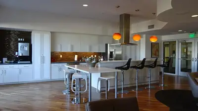 a kitchen with a table and some chairs at Ariva in San Diego
