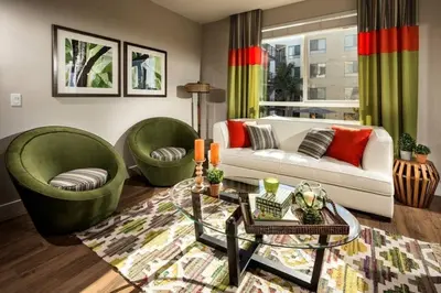 a living room with two green chairs and a couch at Ariva in San Diego