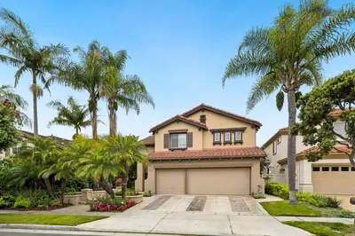 a house with palm trees and a garage at Exquisite Panoramic View Estate in Newport Beach