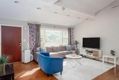a living room with a couch and a tv at Stunning House in Heart of PB in San Diego