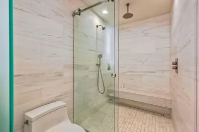 a bathroom with a shower with a toilet at Aqua Luxe - SUR113 in Solana Beach