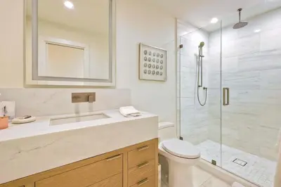 a bathroom with a shower and a toilet and a sink at Aqua Luxe - SUR113 in Solana Beach