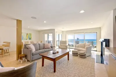 a living room with a view of the ocean at Aqua Luxe - SUR113 in Solana Beach