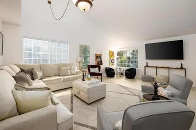 a living room with couches and a flat screen tv at 5 Bedroom Home With Firepit in San Diego