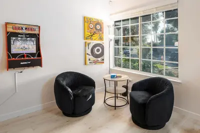 two black chairs and a table in a room at 5 Bedroom Home With Firepit in San Diego