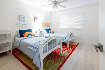 a bedroom with two beds and a ceiling fan at 5 Bedroom Home With Firepit in San Diego