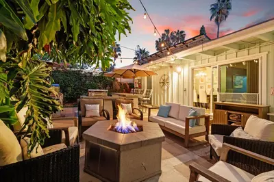 a patio with a fire pit in the middle at Boho Oasis with Pool Spa Firepit BBQ Ping Pong in San Diego