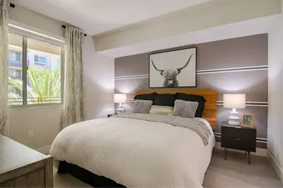 a bedroom with a large bed and a window at Vive on The Park in San Diego