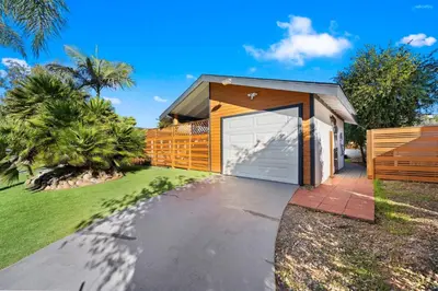 a house with a garage with a fence at Sunny Loft Beaches Lakes Trails in La Mesa