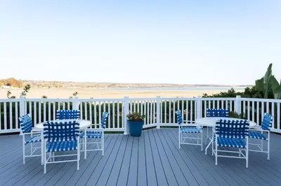 a deck with tables and chairs and the beach at #Marbella Lane - Bayfront Bliss Sunset Views & Pool in San Diego