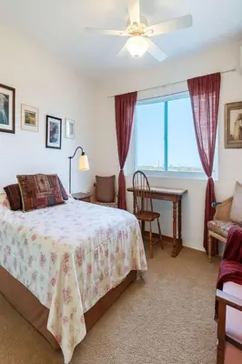a bedroom with a bed and a table and a window at #Marbella Lane - Bayfront Bliss Sunset Views & Pool in San Diego