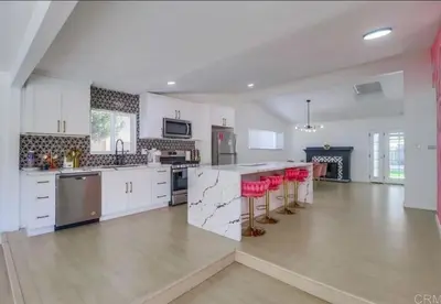 a large kitchen with white cabinets and red stools at Events Allowed: Sunny Villa| Lake| Trails| Beach in La Mesa