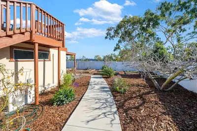 a garden with a walkway next to a house at Westinghouse Park Retreat Decks, BBQ, Fire Pits in San Diego