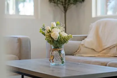 a vase of flowers sitting on a coffee table at Westinghouse Park Retreat Decks, BBQ, Fire Pits in San Diego