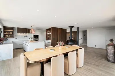 a kitchen and dining room with a wooden table and chairs at Solana Beach Luxury with Panoramic Ocean Views in Solana Beach