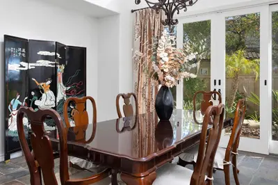 a dining room table with a vase on it at Luxury Gated Retreat Views Trails & Resort Pool in Carlsbad