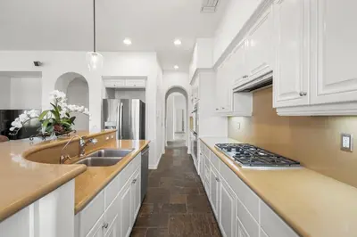 a kitchen with white cabinets and a sink at Luxury Gated Retreat Views Trails & Resort Pool in Carlsbad