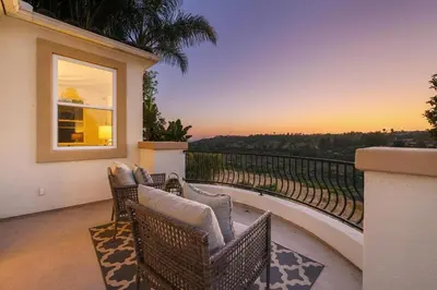 a patio with wicker chairs and a balcony with a view at Luxury Gated Retreat Views Trails & Resort Pool in Carlsbad